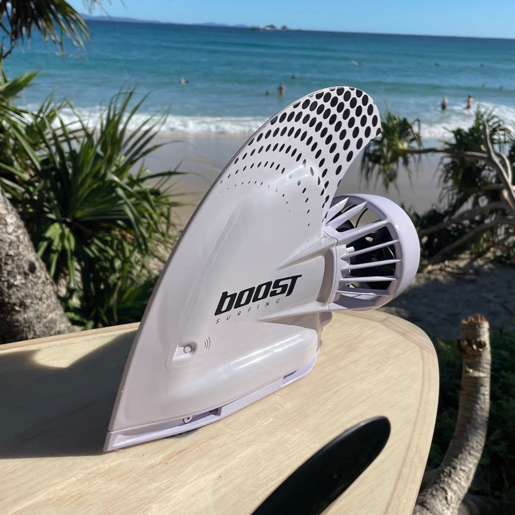 Boost Surfing Fin on a wooden surfboard in front of an Australian beach